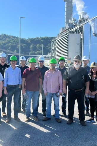 People with hardhats touring an energy facility